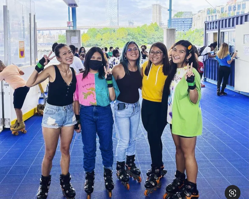 five girls posing for a photo and smiling