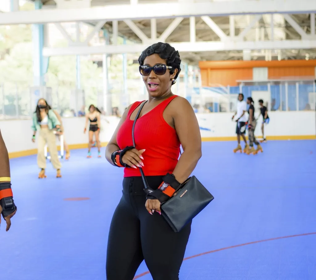 lady with happy smile wearing a red shirt and black pants