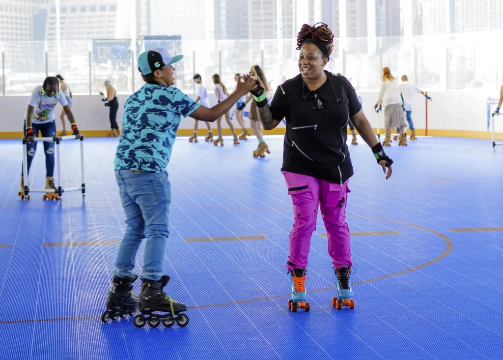 mom and son high five as the skate by each other