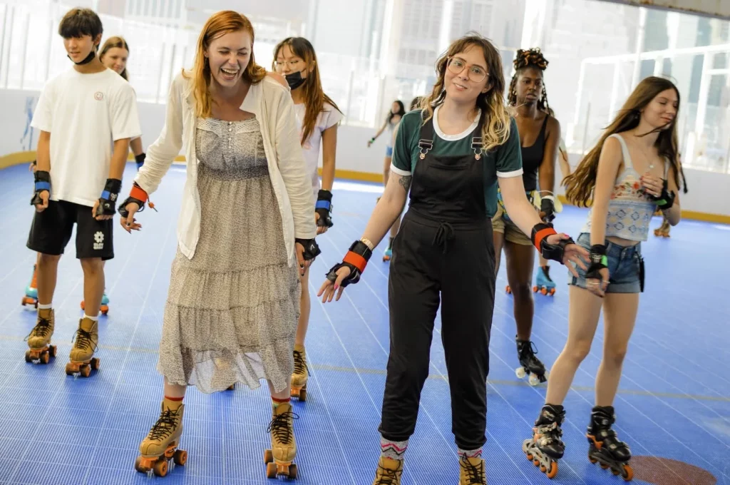 group of seven girls laughing while skating