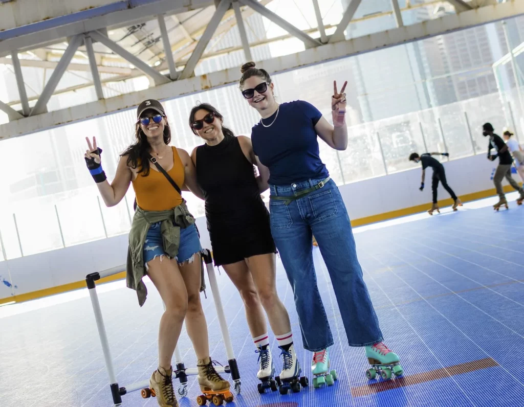 three young ladies holding up a peace sign